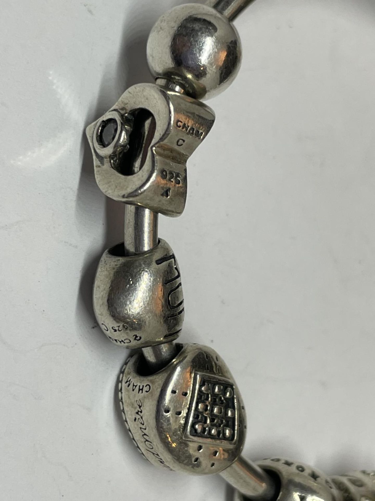 A MARKED SILVER CHAMILIA BRACELET WITH SEVEN CHARMS - Image 2 of 4