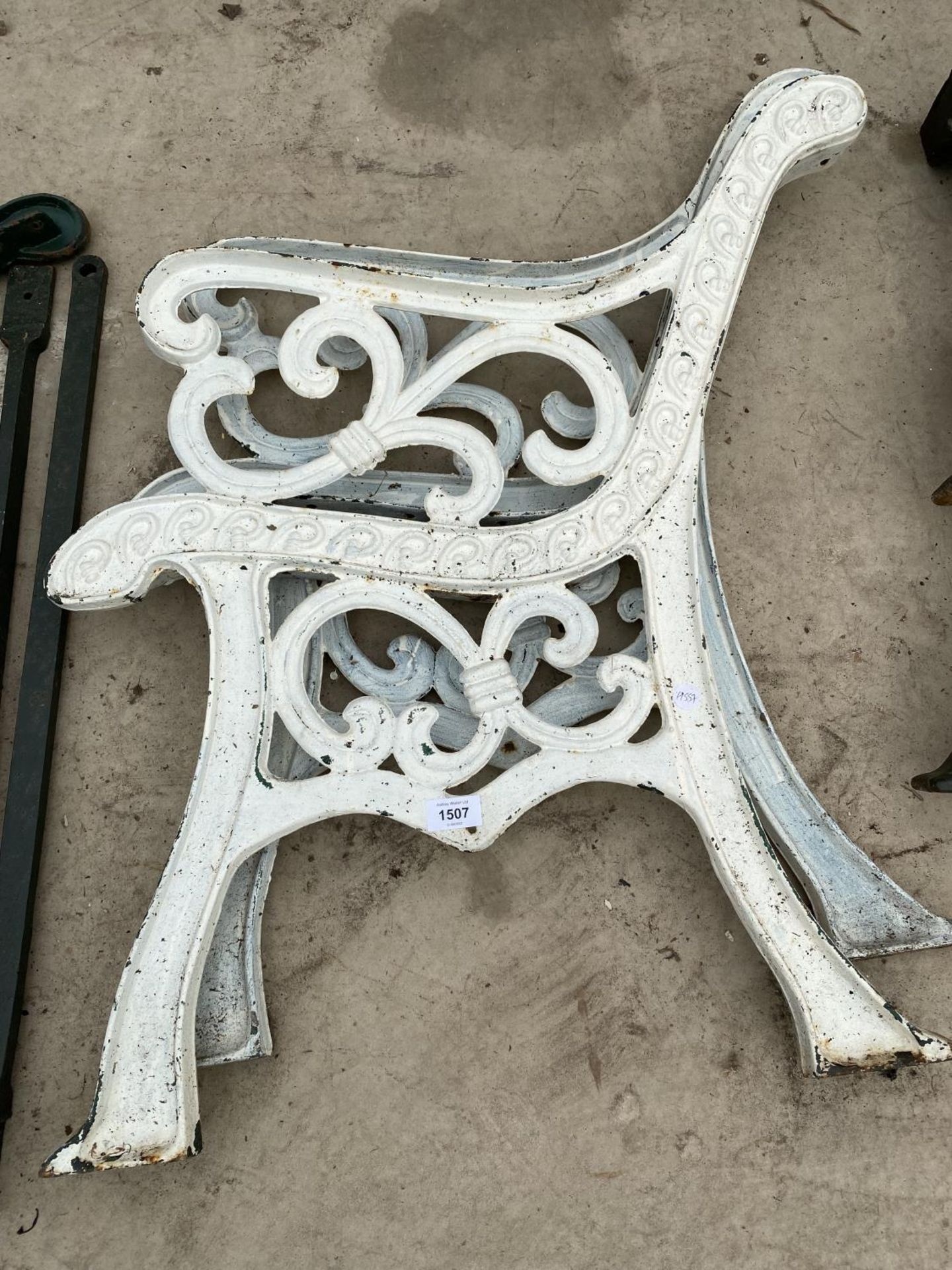 A PAIR OF WHITE PAINTED DECORATIVE CAST BENCH ENDS