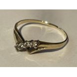 A 9 CARAT GOLD WISHBONE RING WITH FOUR IN LINE CLEAR STONES SIZE P/Q IN A PRESENTATION BOX