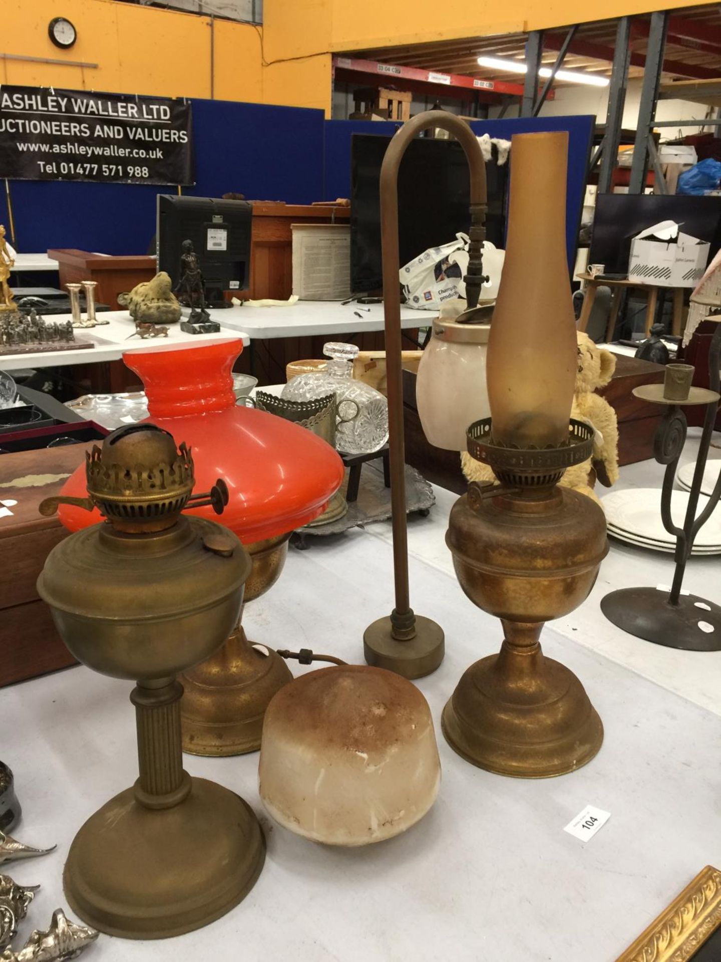 THREE BRASS OIL LAMPS - TWO MISSING CHIMNEYS PLUS A BRASS AND GLASS VERITAS LAMP