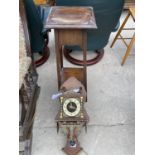 AN OAK TWO TIER JARDINIERE STAND AND DUTCH STYLE WALL CLOCK