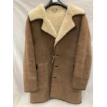 A BUTTON THROUGH SHEEPSKIN COAT, MADE IN SCOTLAND