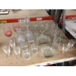 AN ASSORTMENT OF GLASSWARE TO INCLUDE DECANTERS, BOWLS, VASES, GLASSES, ETC