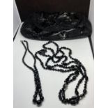 A BLACK BEADED BAG WITH TWO MATCHING NECKLACES