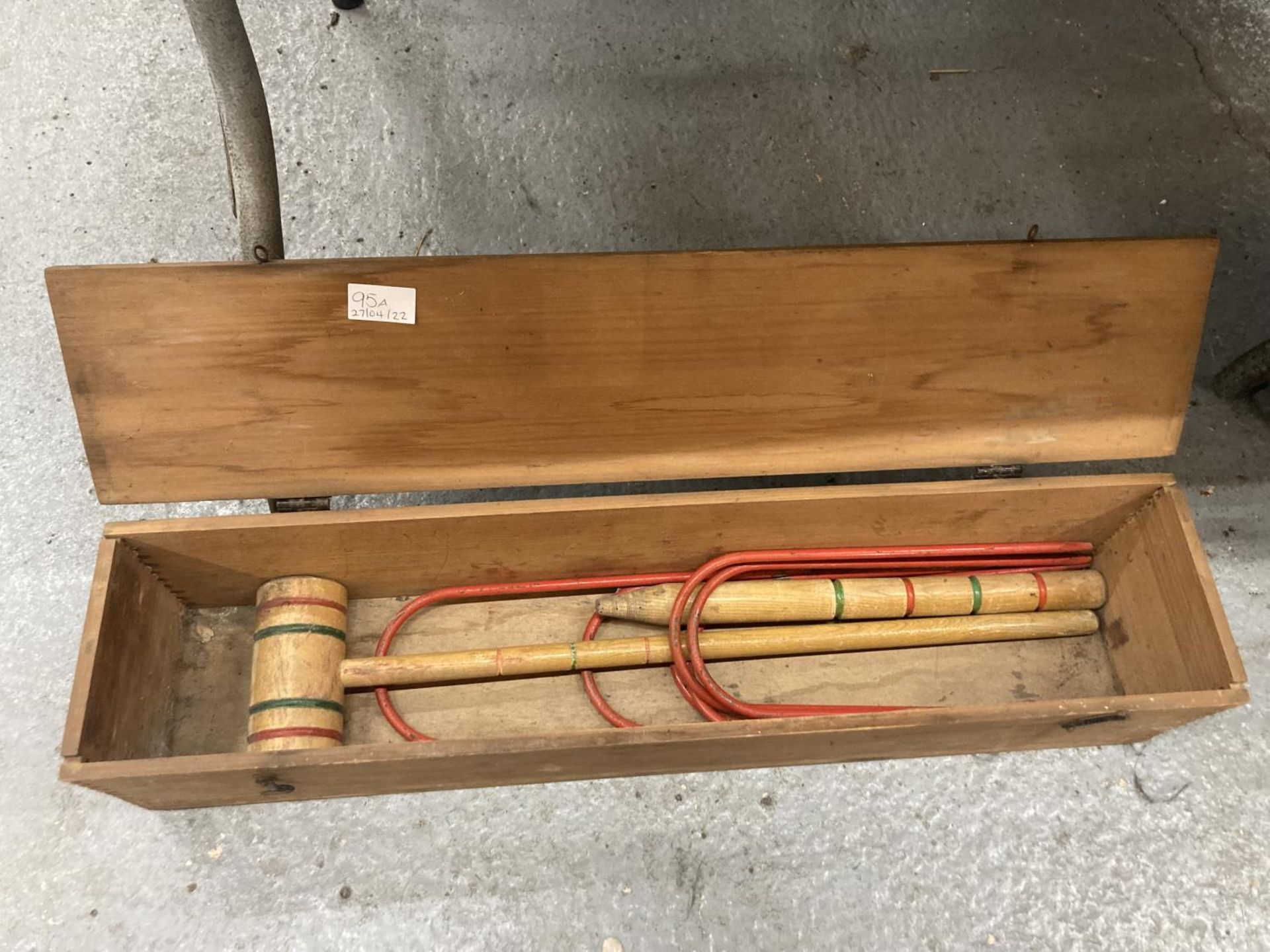 A BOXED TRI-ANG CROQUET SET CONTAINING 1 MALLET, 1 PEG AND FIVE HOOPS