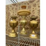 THREE VINTAGE BRASS OIL LAMPS TO INCLUDE ONE CONVERTED TO ELECTRIC WITH A GLASS SHADE