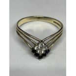 A 9 CARAT THREE STRAND WISHBONE RING WITH A DIAMOND SHAPE DESIGN MADE UP OF FIVE SAPPHIRES AND