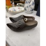 A PAIR OF MINIATURE WOODEN CLOGS WITH CARVED FRONTS