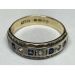 A 9 CARAT GOLD RING WITH FIVE SQUARE SAPPHIRES AND FIVE CLEAR STONES IN A BAND SIZE K