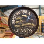 A WOODEN GUINNESS BARREL TOP STYLE SIGN