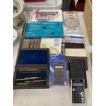 A COLLECTION OF STATIONERY ITEMS INCLUDING A MAHOGANY BOXED DRAWING SET, CALCULATORS, COMPASSES,