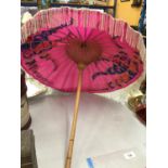 A WOODEN HANDLED PARASOL WITH A PINK AND FLORAL CANOPY - THAILAND, BANGKOK, 1984