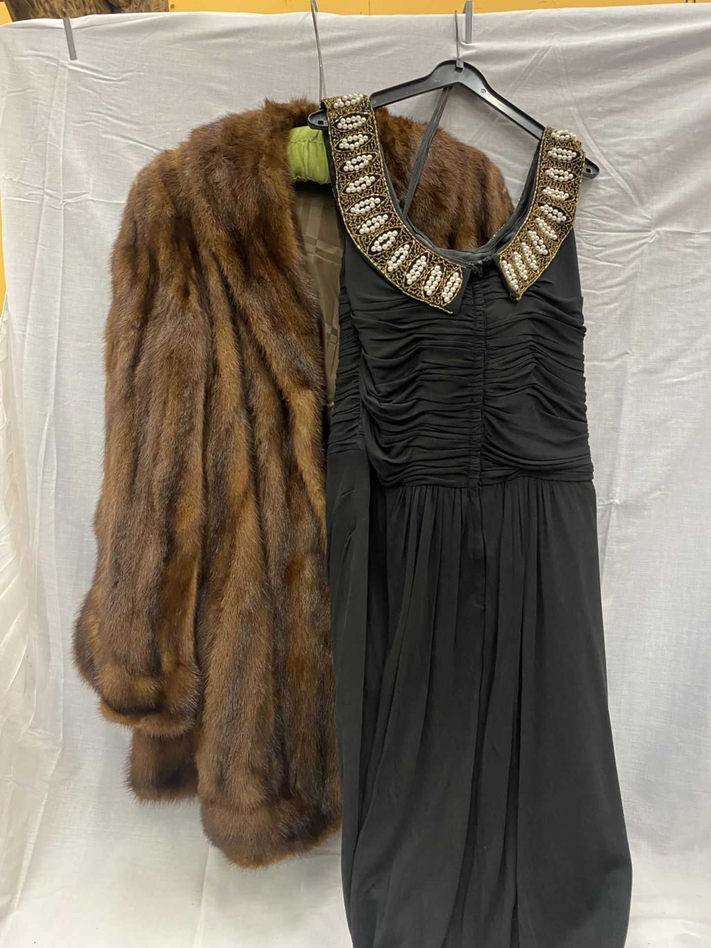 A FUR 3/4 LENGTH JACKET AND A BLACK RUSSELL STUART EVENING DRESS