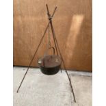 A VINTAGE CAST IRON COOKING POT WITH METAL HANGING STAND