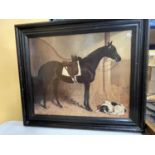 A DARK FRAMED PRINT OF A HORSE AND A DOG IN A STABLE