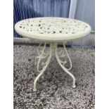 A ROUND METAL BISTRO TABLE