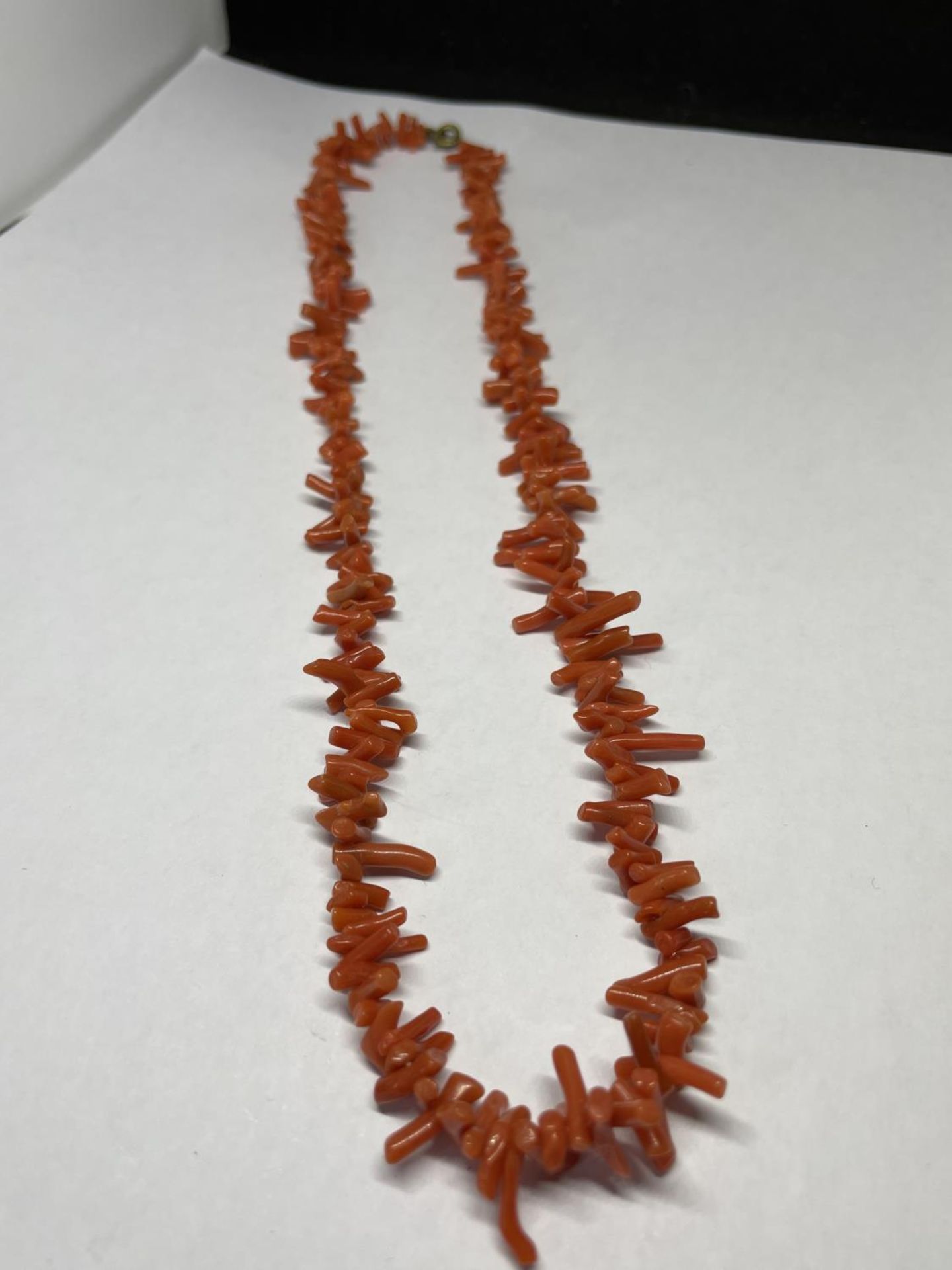 A CORAL NECKLACE IN A PRESENTATION BOX