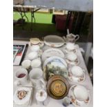 A QUANTITY OF CERAMICS AND CHINA TO INCLUDE CUPS AND SAUCERS, COMMEMORATIVE ITEMS, WALL PLATES,