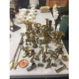 A LARGE QUANTITY OF BRASSWARE TO INCLUDE FIGURES, BELLS, BOWLS, CANDLESTICKS, ETC