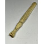 A CARVED BONE CHEROOT HOLDER IN THE GUISE OF A CROCODILE