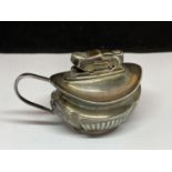 A SILVER PLATED TABLE LIGHTER IN THE FORM OF A JUG