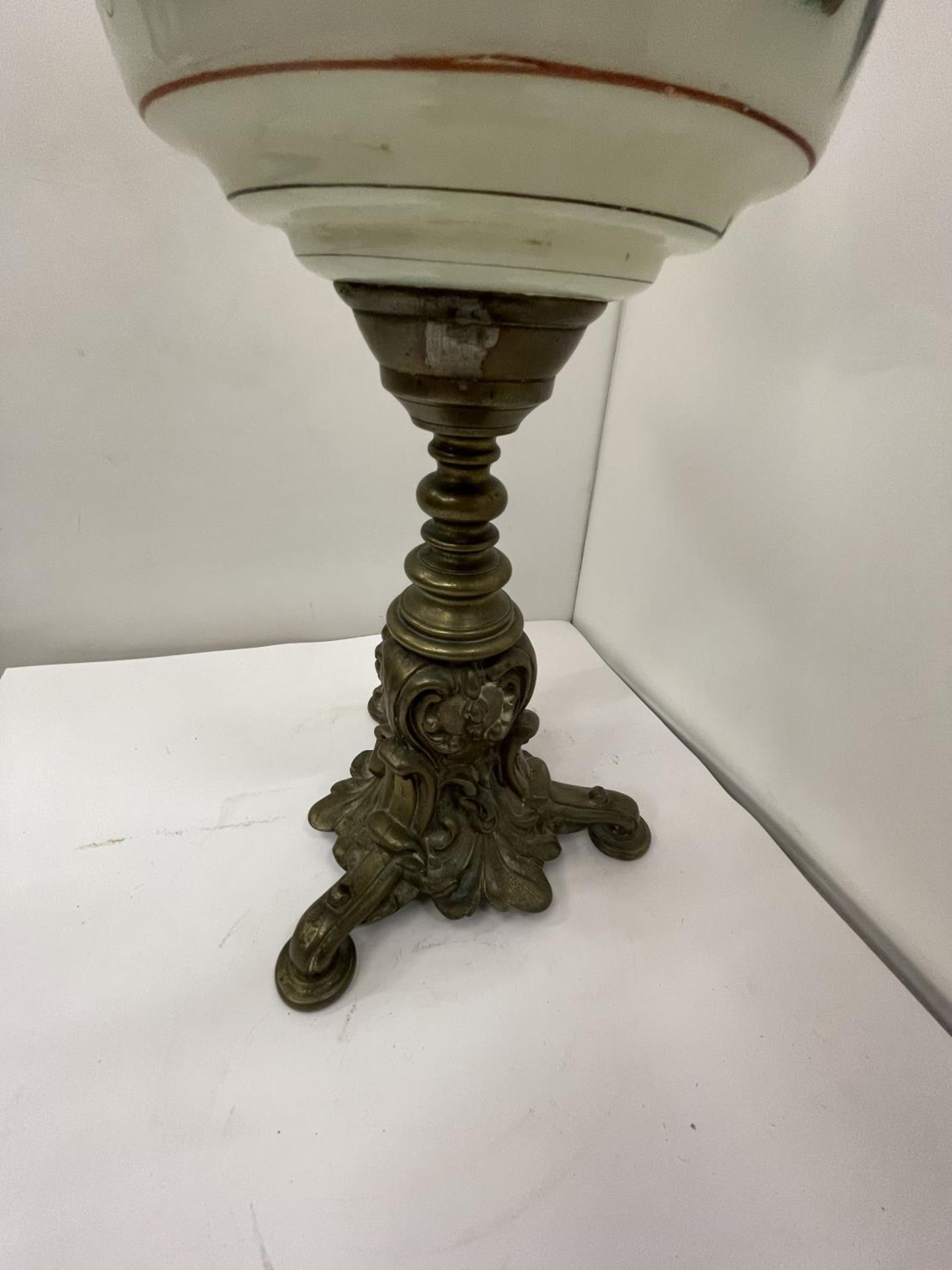 A BRASS OIL LAMP WITH DECORATIVE RESRVOIR, GLASS FUNNEL AND CRANBERRY GLASS SHADE - Image 5 of 5