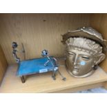 A DECORATIVE MODEL FORMED FROM NUTS AND BOLTS AND A METAL GREEK HEAD