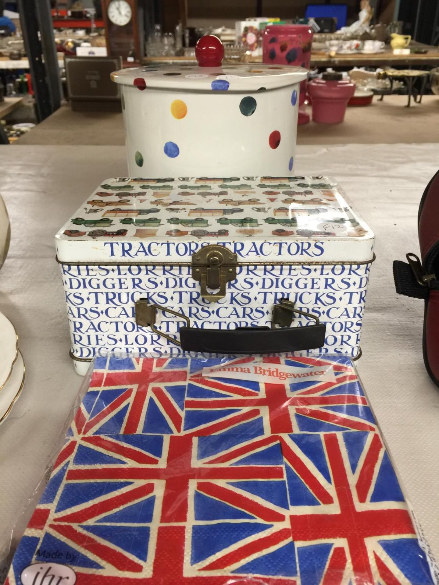 AN EMMA BRIDGEWATER BISCUIT BARREL, EMMA BRIDGEWATER UNION JACK SERVIETTES AND A VINTAGE TRACTORS