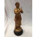 A GOLD COLOURED FIGURE OF A WOMAN ON A PLINTH HEIGHT 51CM