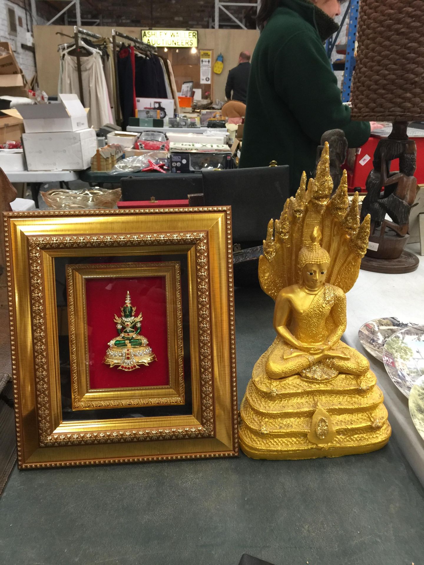 A GOLD COLOURED FIGURE OF A DEITY AND A FRAMED 3D DEITY