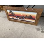 A FRAMED PRINT OF A DESERT SCENE