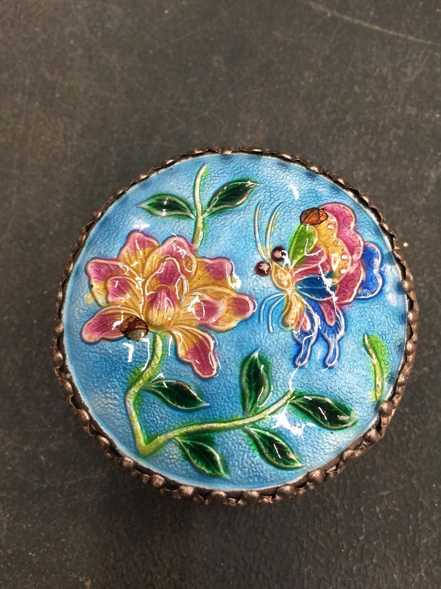 A SILVER PLATED LIDDED BOX WITH AN ENAMEL LID