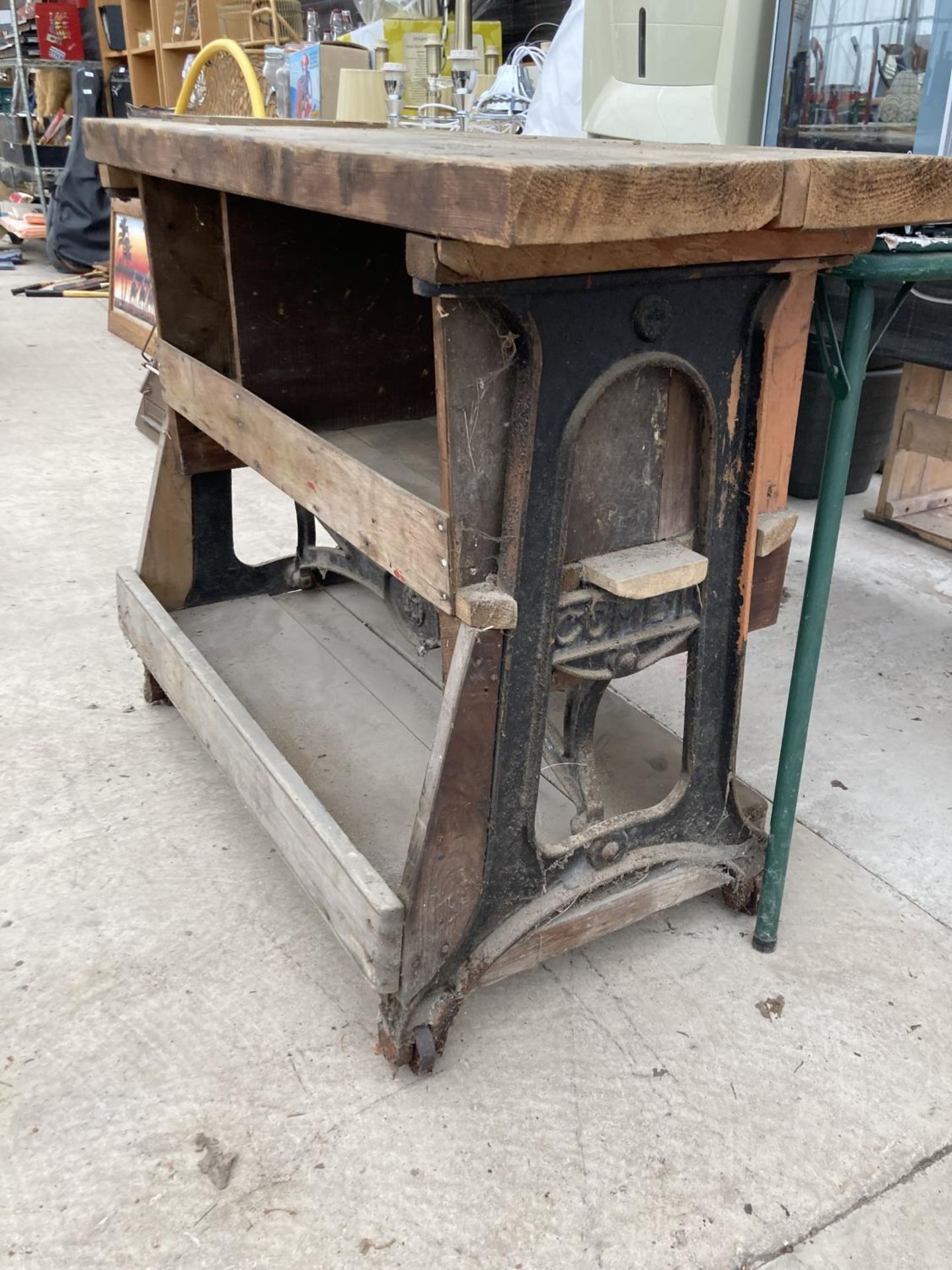 A VINTAGE WOODEN WORK BENCH WITH CAST IRON WHEELED BASE - Image 3 of 3