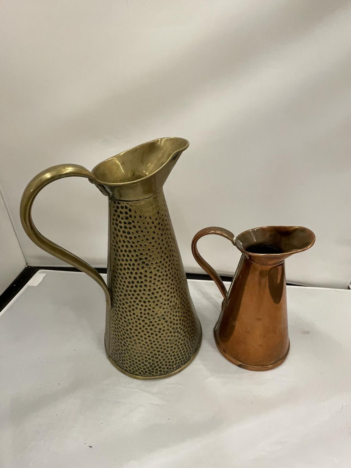 TWO JUGS BY JOSEPH SANKEY AND SONS ONE BEATEN BRASS AND ONE COPPER