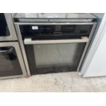 A CHROME AND BLACK INTERGRATED NEFF OVEN