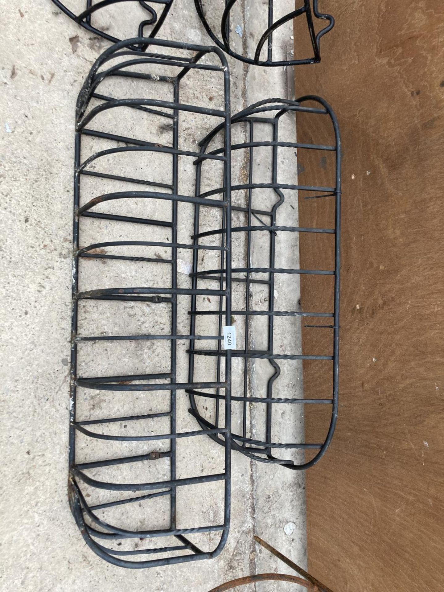 A PAIR OF WROUGHT IRON HAY RACK PLANTERS