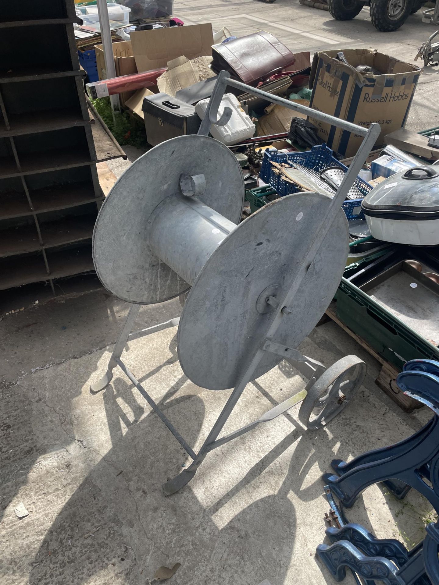 A VINTAGE GALVANISED CABLE REEL ON WHEELS