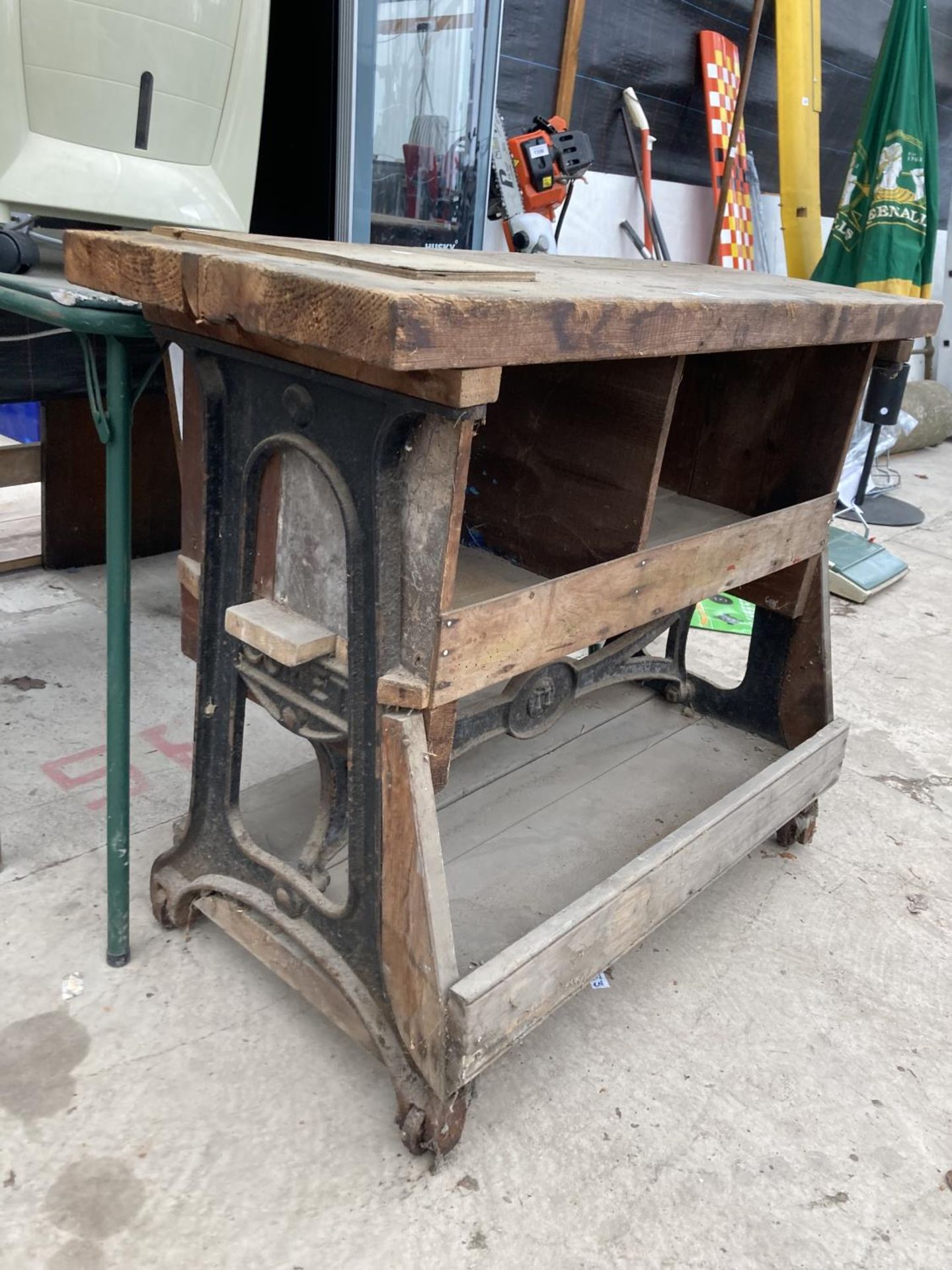A VINTAGE WOODEN WORK BENCH WITH CAST IRON WHEELED BASE - Image 2 of 3
