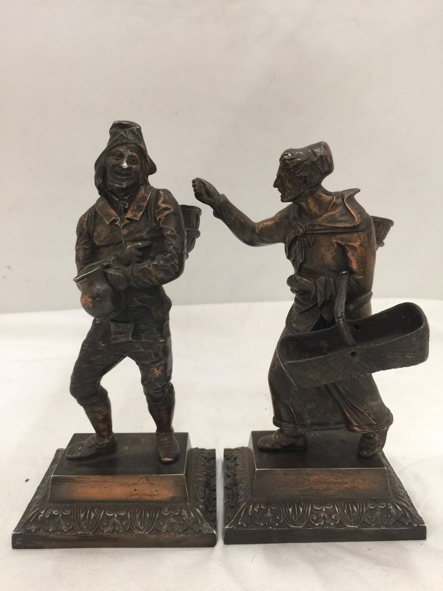 A PAIR OF BRONZE DIPPED FRENCH GRAPE PICKER METAL FIGURINES