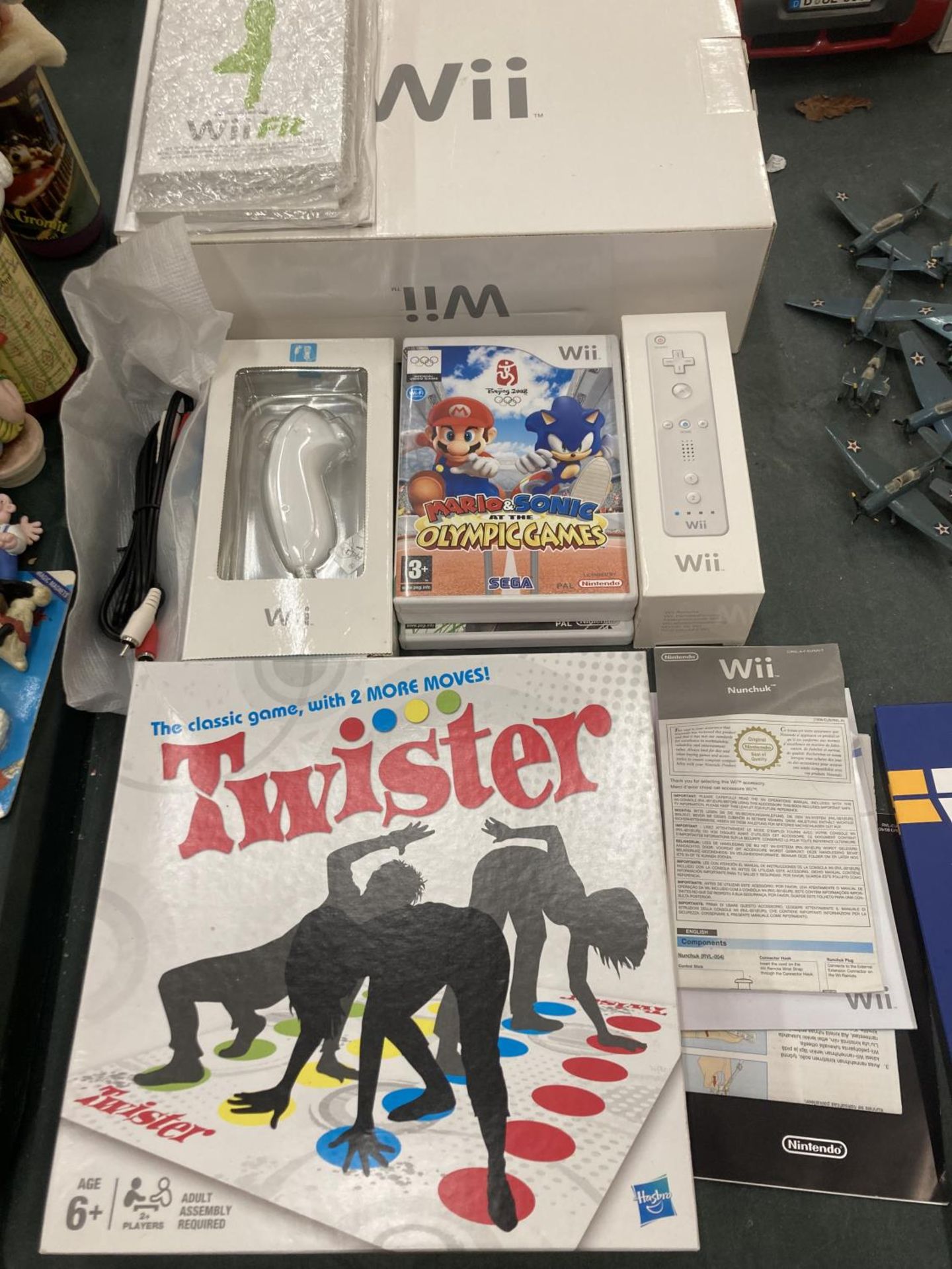 A BOXED NINTENDO Wii CONSOLE WITH HAND CONTROLLER, NUNCHUCK AND GAMES TO INCLUDE MARIO AND SONIC AND