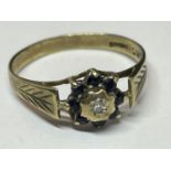 A 9 CARAT GOLD RING WITH A CENTRE DIAMONDS SURROUNDED BY EIGHT SAPPHIRES SIZE O