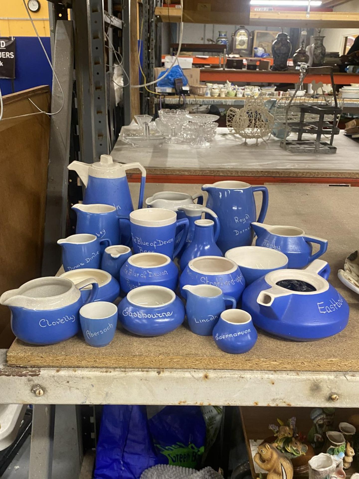 A COLLECTION OF BLUE AND CREAM 'TORQUAY WARE' TO INCLUDE JUGS, BOWLS, EGG CUPS, ETC