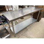 A LARGE STAINLESS STEEL TWO TIER KITCHEN UNIT
