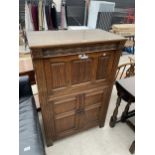 AN OAK OLD CHARM STYLE LINENFOLD COCKTAIL CABINET