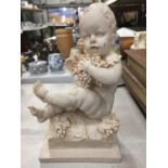 A STATUETTE OF A CHILD WITH GRAPES HEIGHT 26CM