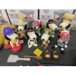 A COLLECTION OF SNOOPY FIGURES IN VARIOUS COSTUMES