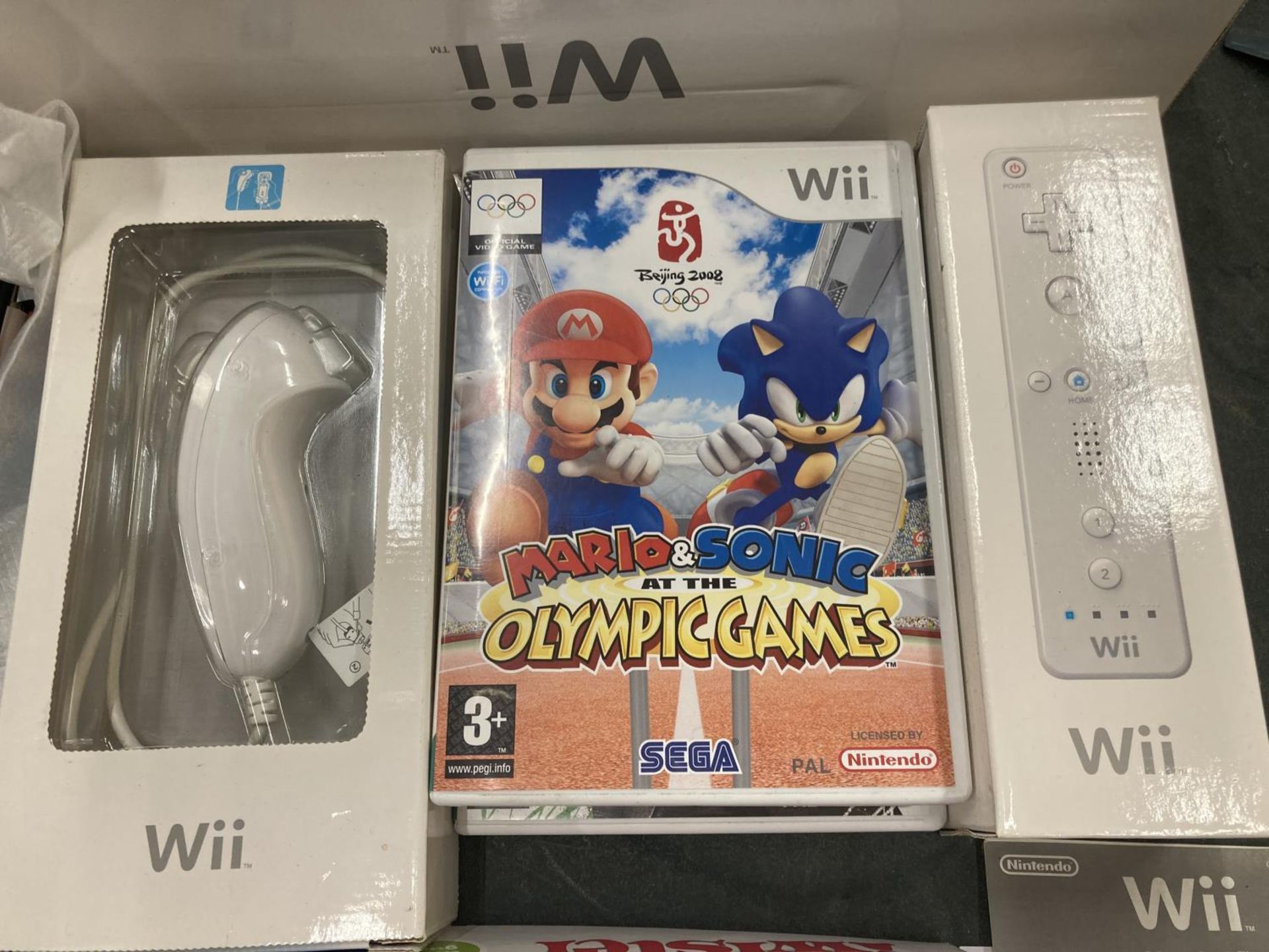 A BOXED NINTENDO Wii CONSOLE WITH HAND CONTROLLER, NUNCHUCK AND GAMES TO INCLUDE MARIO AND SONIC AND - Image 2 of 3