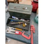 A METAL TOOL BOX WITH AN ASSORTMENT OF TOOLS TO INCLUDE CLAMPS, A SPANNER AND SOCKETS ETC