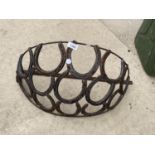 A WROUGHT IRON HAY RACK PLANTER FORMED FROM HORSE SHOES