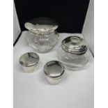 FOUR LIDDED POTS TWO BEING GLASS WITH HALLMARKED BIRMINGHAM SILVER LIDS AND TWO COMPLETELY